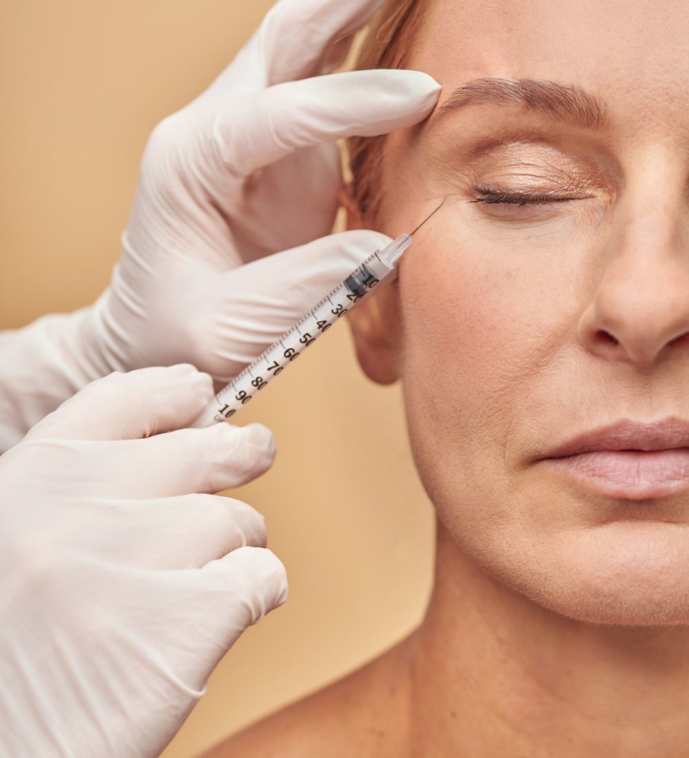 vertical-shot-beautician-hands-white-protective-gloves-with-syringe-making-cosmetic-injection